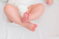 A baby's legs and feet.