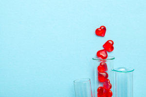 Hearts extending out of a test tube.